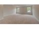 Large bonus room with carpeted floors and natural light from multiple windows at 234 Linford Dr, Locust Grove, GA 30248