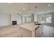 Open-concept living space featuring a kitchen island that connects to a spacious living room with a fireplace at 234 Linford Dr, Locust Grove, GA 30248