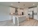 Bright kitchen features white cabinets, stainless steel appliances, and a central island with pendant lighting at 234 Linford Dr, Locust Grove, GA 30248