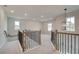 Open landing area with iron railings, staircase, and natural light from windows at 234 Linford Dr, Locust Grove, GA 30248