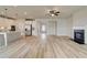 The kitchen and open living area showcasing an island and a modern fireplace, seamlessly connected at 234 Linford Dr, Locust Grove, GA 30248
