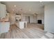 Open living area features a modern kitchen, stainless steel appliances, and cozy fireplace at 234 Linford Dr, Locust Grove, GA 30248