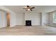 Spacious living room with a fireplace and a ceiling fan, offering a cozy and inviting atmosphere at 234 Linford Dr, Locust Grove, GA 30248