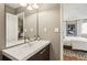 Modern bathroom vanity with a sink, a decorative mirror and a bedroom in the background at 3268 Clairmont Ne, Brookhaven, GA 30329