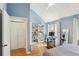 Bright bedroom with a vaulted ceiling, closet, and a workspace setup by the window at 3268 Clairmont Ne, Brookhaven, GA 30329