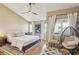 Stylish bedroom with a modern ceiling fan, windows, and a comfortable lounge chair at 3268 Clairmont Ne, Brookhaven, GA 30329