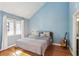 Bedroom featuring light blue walls, a window, and hardwood floors at 3268 Clairmont Ne, Brookhaven, GA 30329