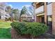 Townhome with manicured landscaping, mature trees, and attractive brick facade at 3268 Clairmont Ne, Brookhaven, GA 30329