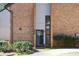 Brick exterior facade with a modern-looking black front door and manicured shrubs creating curb appeal at 3268 Clairmont Ne, Brookhaven, GA 30329