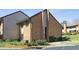 View of an exterior elevation showcasing brick facade with landscaping and driveway approach at 3268 Clairmont Ne, Brookhaven, GA 30329