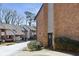 Charming brick townhome with a black door and landscaping, nestled in a quiet community at 3268 Clairmont Ne, Brookhaven, GA 30329