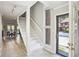 Inviting foyer with white staircase and large window offering natural light at 3268 Clairmont Ne, Brookhaven, GA 30329
