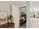 Hallway featuring mirrored walls, stylish lighting, and a storage closet with shelving at 3268 Clairmont Ne, Brookhaven, GA 30329