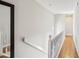 Bright hallway with hardwood floors, leading to additional rooms and featuring staircase access at 3268 Clairmont Ne, Brookhaven, GA 30329