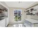 Bright laundry room with a window and built-in shelving for organized storage at 3268 Clairmont Ne, Brookhaven, GA 30329