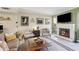 Relaxing living room with a fireplace, hardwood floors, and lots of natural light streaming through large windows at 3268 Clairmont Ne, Brookhaven, GA 30329