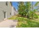 A view of the backyard between two houses with green grass and a small concrete patio at 5567 Union Pointe Pl, Union City, GA 30291
