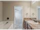 Bathroom featuring a vanity with marble top, a tub, and a doorway to the bedroom at 5567 Union Pointe Pl, Union City, GA 30291