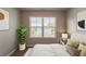 Bedroom featuring a large window with blinds, artwork and stylish decor at 5567 Union Pointe Pl, Union City, GA 30291