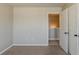 Neutral bedroom showcasing an open closet with white paneled doors and carpeted floors at 5567 Union Pointe Pl, Union City, GA 30291