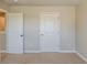 Bedroom showcasing neutral walls, white paneled doors, and carpeted floors at 5567 Union Pointe Pl, Union City, GA 30291