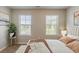 Bedroom featuring two windows, artwork, and stylish decor at 5567 Union Pointe Pl, Union City, GA 30291