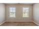Carpeted bedroom with two windows providing an abundance of natural light at 5567 Union Pointe Pl, Union City, GA 30291