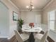 Cozy dining room features stylish round table, modern chairs, hardwood floors, and wainscoting at 5567 Union Pointe Pl, Union City, GA 30291
