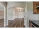 Elegant dining room with wood floors, wainscoting, chandelier, and open arched doorway to adjacent living space at 5567 Union Pointe Pl, Union City, GA 30291