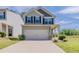 Charming two-story home featuring a two-car garage, well-maintained lawn, and inviting covered porch area at 5567 Union Pointe Pl, Union City, GA 30291