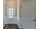 Entryway featuring a glass door allowing natural light, wainscoting, and hardwood floors at 5567 Union Pointe Pl, Union City, GA 30291