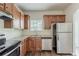 Well-equipped kitchen with stainless steel appliances, granite countertops, tile backsplash, and wooden cabinets at 5567 Union Pointe Pl, Union City, GA 30291