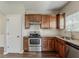 Modern kitchen featuring stainless steel appliances, beautiful granite countertops, and ample wooden cabinetry at 5567 Union Pointe Pl, Union City, GA 30291