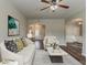 Comfortable living room featuring hardwood floors, modern furniture, and a large window for ample natural light at 5567 Union Pointe Pl, Union City, GA 30291