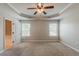 Spacious main bedroom with carpet flooring, tray ceiling, and adjoining bath at 5567 Union Pointe Pl, Union City, GA 30291