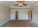 Main bedroom with plush carpet, tray ceiling, and view of walk-in closet at 5567 Union Pointe Pl, Union City, GA 30291
