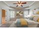 Stylishly decorated main bedroom with bed, ceiling fan, and ensuite bathroom at 5567 Union Pointe Pl, Union City, GA 30291