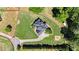 Aerial view showcasing the property's layout, lush lawns, driveway, and surrounding trees at 104 Meadow View Trl, Canton, GA 30115