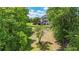 Spacious backyard with lush lawn, mature trees, and a glimpse of the home's exterior at 104 Meadow View Trl, Canton, GA 30115
