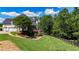 Expansive backyard with lush lawn, mature trees, and a charming deck, creating a private outdoor retreat at 104 Meadow View Trl, Canton, GA 30115