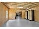 Unfinished basement with exposed insulation, plywood walls, and a gray painted floor at 104 Meadow View Trl, Canton, GA 30115