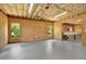 Unfinished basement with plywood walls, exposed insulation, and bright windows at 104 Meadow View Trl, Canton, GA 30115