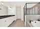 Bathroom with dual sink vanity, soaking tub, and glass enclosed shower, with neutral tile floor at 104 Meadow View Trl, Canton, GA 30115