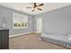 Neutral-toned bedroom with great light features a window, modern ceiling fan, and carpeted floor at 104 Meadow View Trl, Canton, GA 30115