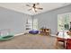 A naturally lit bonus room includes both a trampoline and a bookshelf, perfect for various activities at 104 Meadow View Trl, Canton, GA 30115