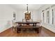 Formal dining room featuring a wooden table with upholstered chairs and bench seating at 104 Meadow View Trl, Canton, GA 30115