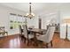 Bright dining room with hardwood floors, white trim, and large windows with shutters at 104 Meadow View Trl, Canton, GA 30115