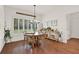 Bright dining room featuring hardwood floors and large windows with plantation shutters at 104 Meadow View Trl, Canton, GA 30115