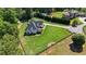 Rear exterior view of a beautiful two-story home with a large, manicured yard and mature trees at 104 Meadow View Trl, Canton, GA 30115
