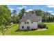 Lush green lawn surrounding a white, two-story home, offering ample space and privacy at 104 Meadow View Trl, Canton, GA 30115